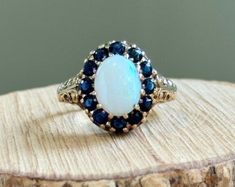 Gold opal and sapphire ring. A vintage 1970s 9k yellow gold blue sapphire and opal ring.