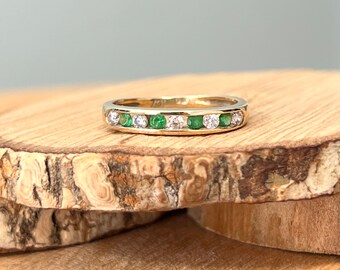 Gold CZ ring. A small sized 9k yellow gold green and white and cubic zirconia ring