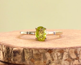 Gold peridot ring. 10K yellow gold green peridot solitaire and diamond ring.