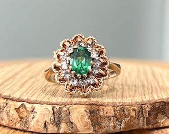 Gold green stone ring. A vintage 9K yellow gold oval cut synthetic green stone with a white stone halo. Conflict free ethical gold ring.