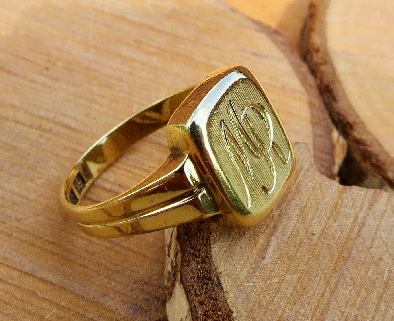 Gold signet ring, a 14K yellow gold engraved monogram ring.