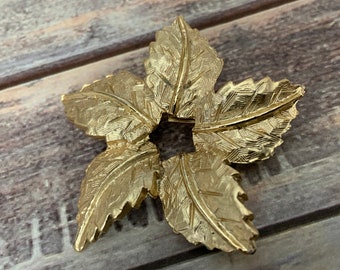 Vintage light gold tone leaf star flower brooch