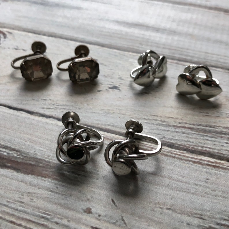 Small lot of silver tone metal screw back earrings knot earrings rhinestone and heart screw back earrings