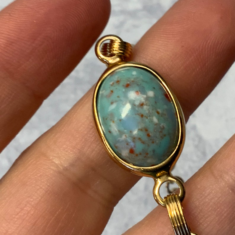 Robbins egg blue glass stone bracelet in gold tone metal