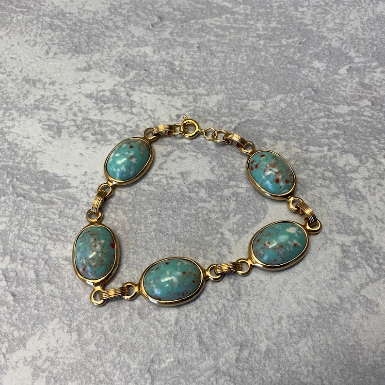 Robbins egg blue glass stone bracelet in gold tone metal