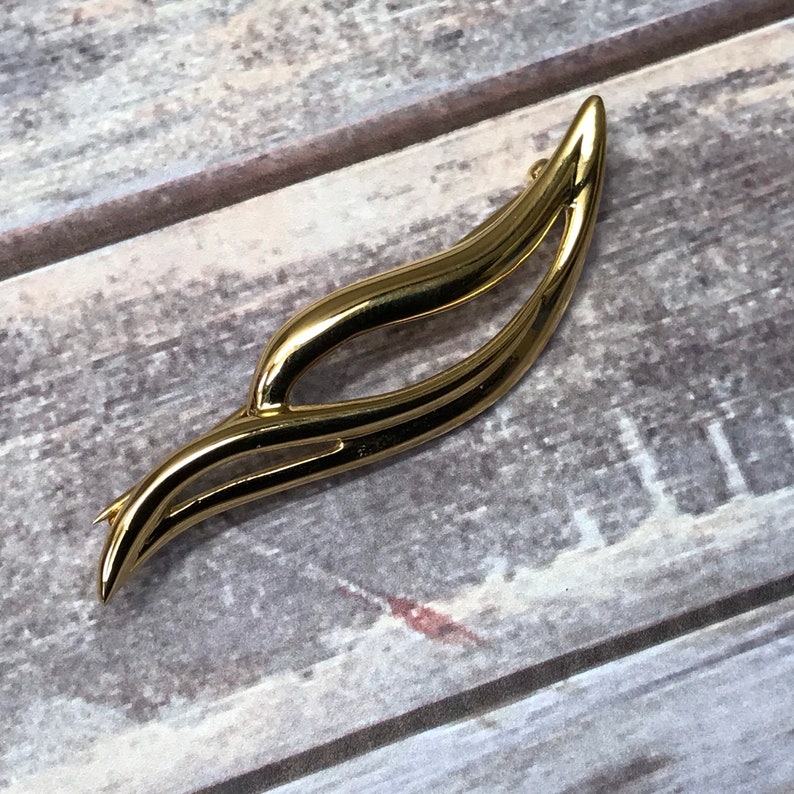 Swirling gold tone Monet bar brooch