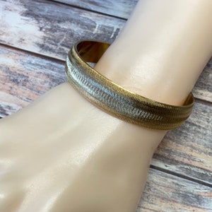Thick textured monet bangle bracelet in gold tone metal