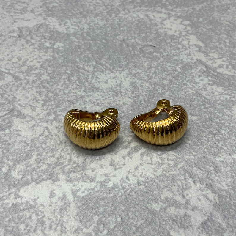 Monet ribbed shrimp style hoop clip on earrings in gold tone metal