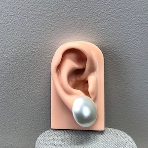 Round white faux pearl clip on earrings in gold tone metal