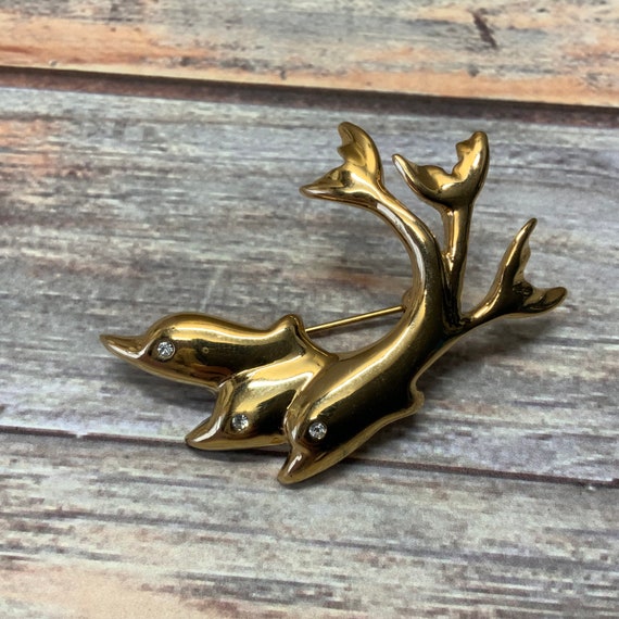Vintage gold tone rhinestone dolphins brooch - image 1