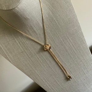 Vintage 1970s rhinestone circle bolo slide lariat necklace in gold tone metal