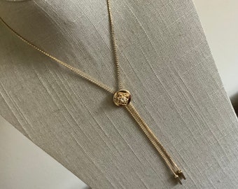 Vintage 1970s rhinestone circle bolo slide lariat necklace in gold tone metal