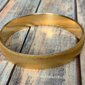 Brushed gold tone Monet wide bangle bracelet