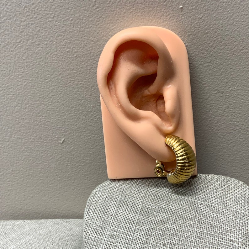 Monet ribbed shrimp style hoop clip on earrings in gold tone metal