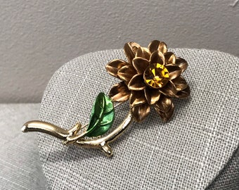 Metal copper colored carnation flower brooch with topaz rhinestone