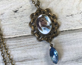 Small acrylic collie dog cameo necklace with pale blue rhinestone dangle in a circle link frame