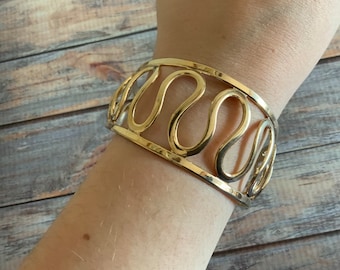 Signed Vintage Sarah Coventry swirling retro cuff bracelet in gold tone