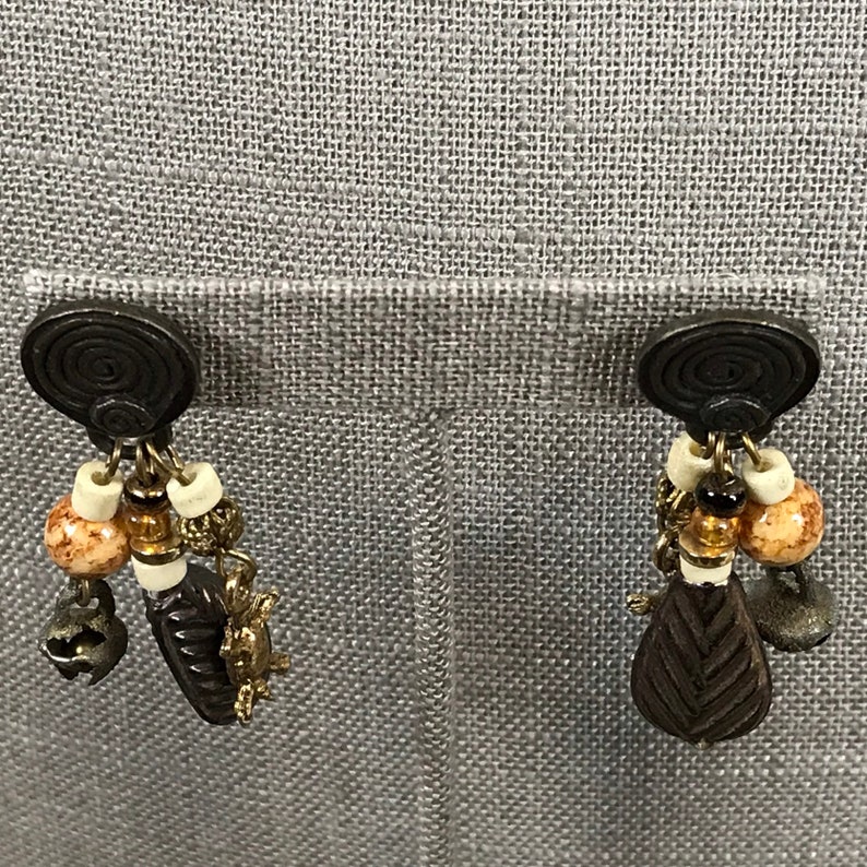 Vintage 1980s tribal pierced dangle earrings with turtle charms