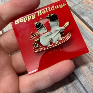 Small vintage enamel sliding snowman holiday brooch in gold tone