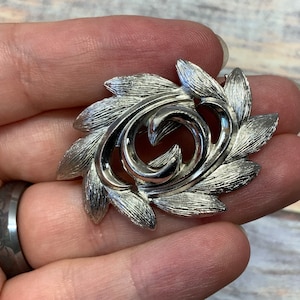 Small brushed silver tone monet swirl leaf brooch