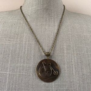 Antique brass penny farthing bycicle necklace