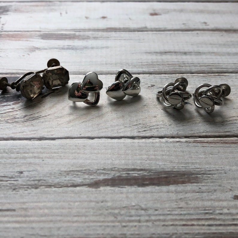 Small lot of silver tone metal screw back earrings knot earrings rhinestone and heart screw back earrings