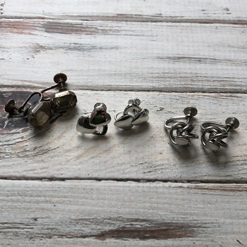 Small lot of silver tone metal screw back earrings knot earrings rhinestone and heart screw back earrings