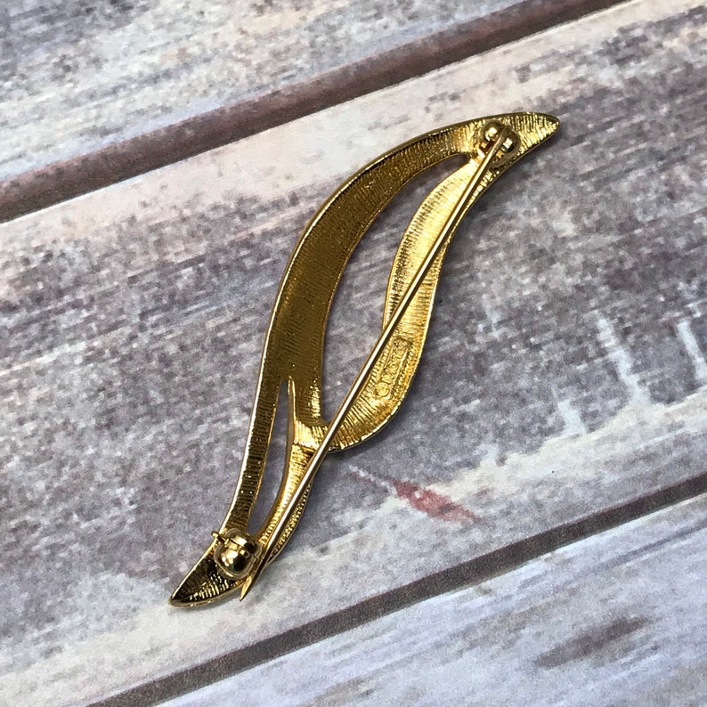 Swirling gold tone Monet bar brooch