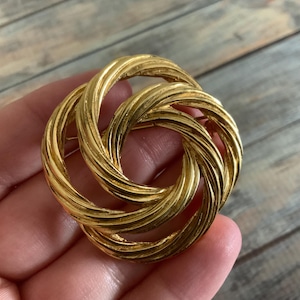Vintage twisted MONET knot brooch in gold tone metal