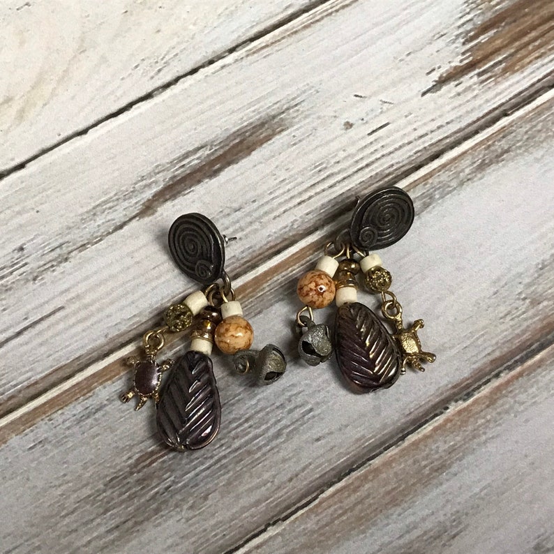 Vintage 1980s tribal pierced dangle earrings with turtle charms