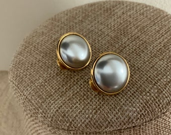 Signed Monet gray faux pearl clip on cabochon circular earrings in gold tone