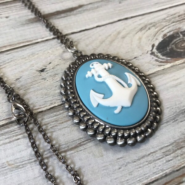 Large white and blue resin anchor cameo necklace in nautical settings on black gun metal chain