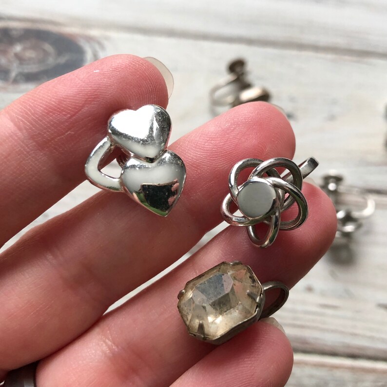 Small lot of silver tone metal screw back earrings knot earrings rhinestone and heart screw back earrings
