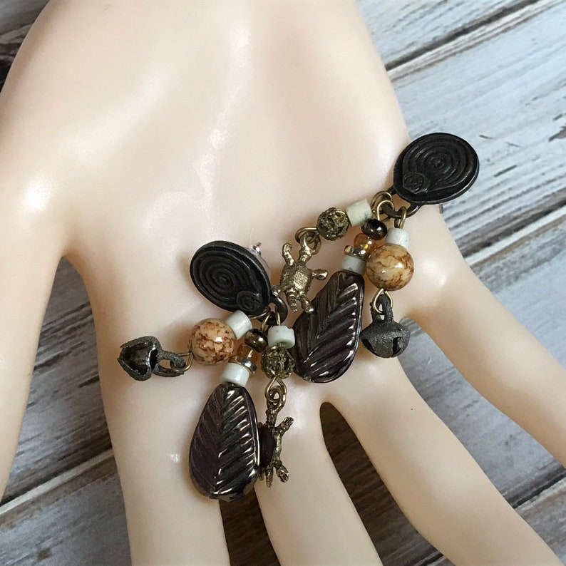 Vintage 1980s tribal pierced dangle earrings with turtle charms