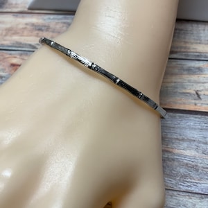 Simple narrow silver tone bamboo style bangle bracelet