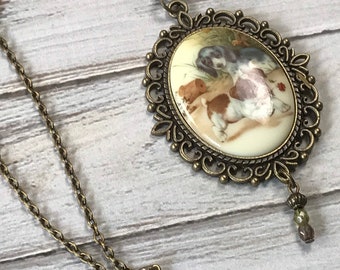 Antique brass puppies playing acrylic cameo necklace with copper bead dangle