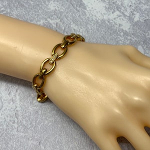 Gold plated oval link tennis bracelet with rhinestone accents