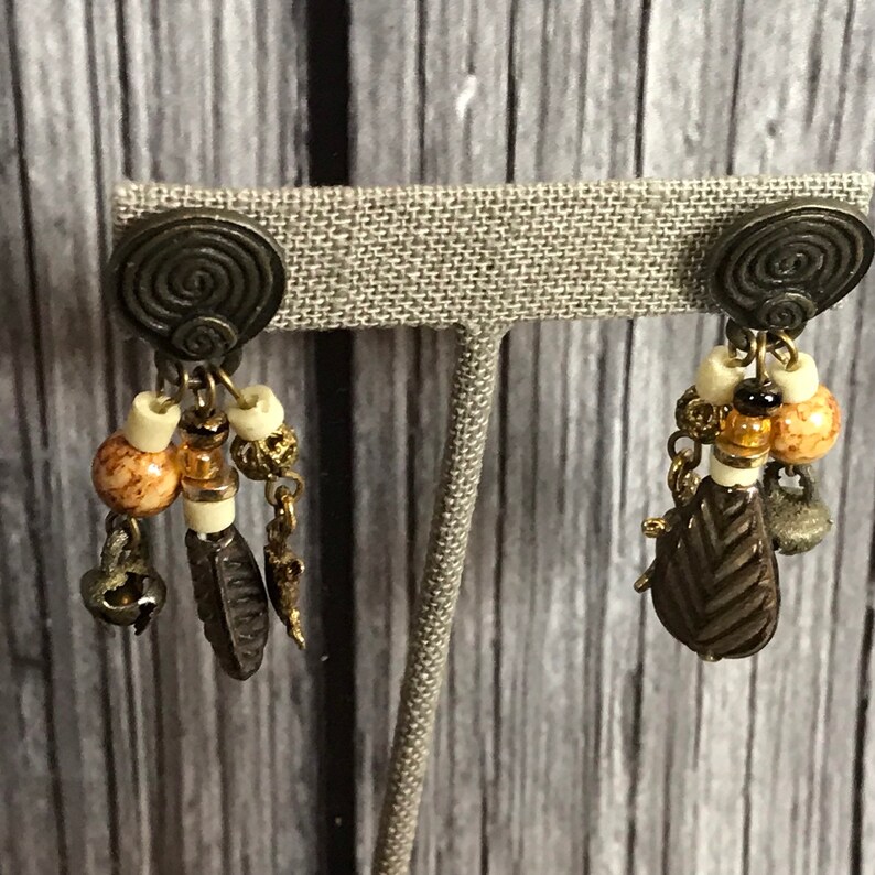 Vintage 1980s tribal pierced dangle earrings with turtle charms
