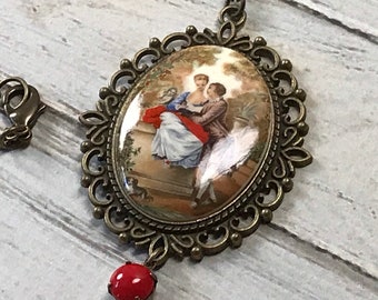 Baroque acrylic lovers cameo necklace with red rhinestone dangle on antique brass chain