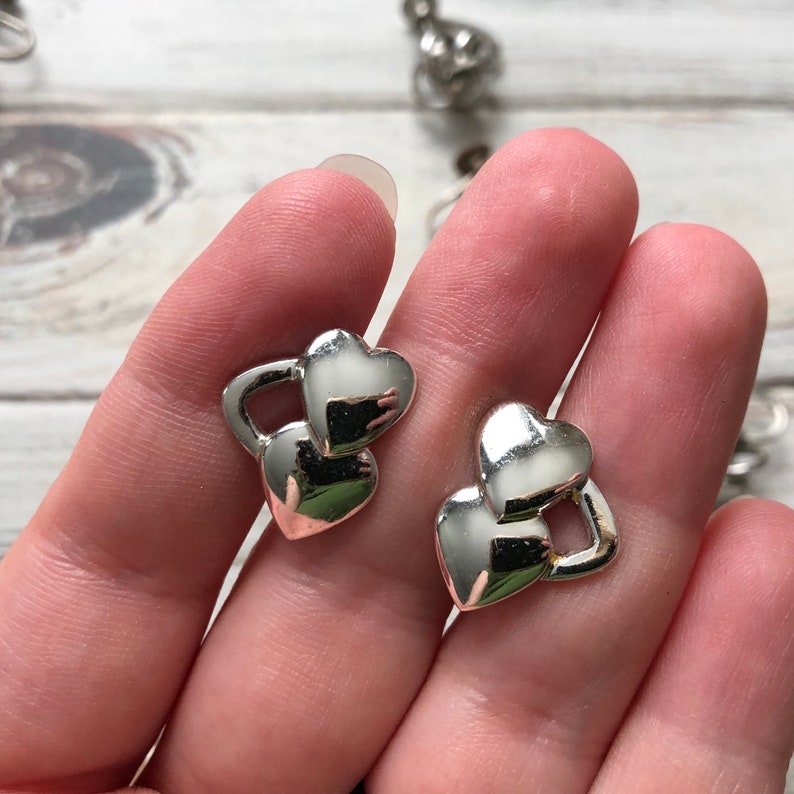 Small lot of silver tone metal screw back earrings knot earrings rhinestone and heart screw back earrings