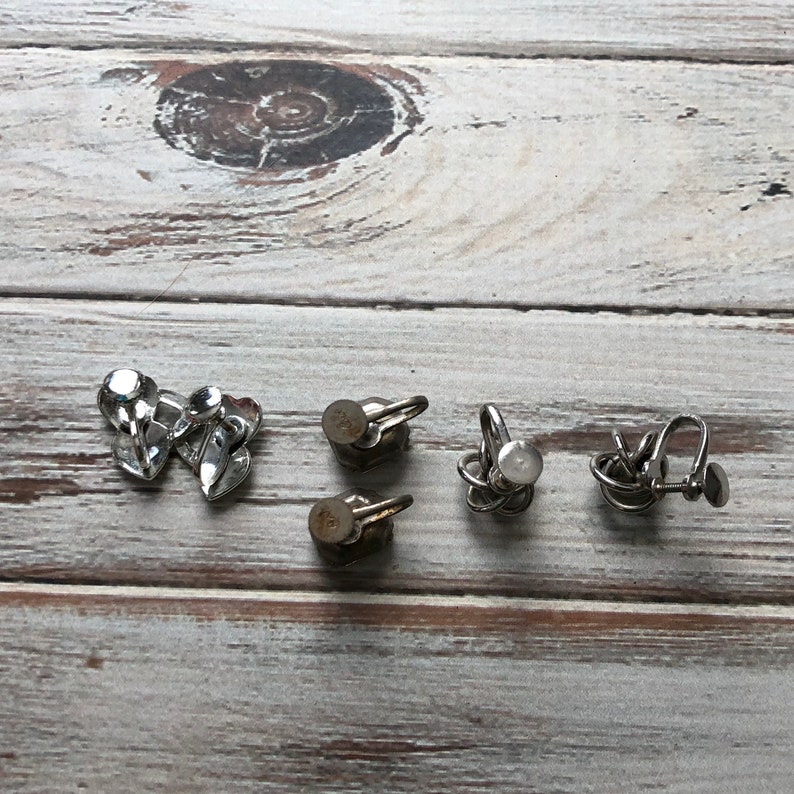 Small lot of silver tone metal screw back earrings knot earrings rhinestone and heart screw back earrings