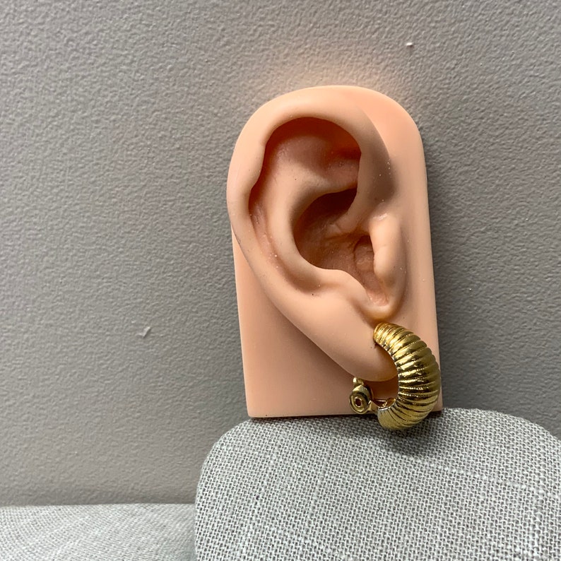 Monet ribbed shrimp style hoop clip on earrings in gold tone metal