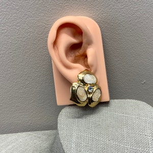 Beige enamel clover flower clip on earrings in gold tone metal