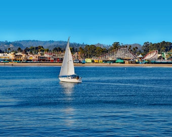 Sailboat Sailing in the Famous Santa Cruz Bay, near the Scenic Boardwalk Carnival Rides, for a Panoramic Carnival View, choose print size