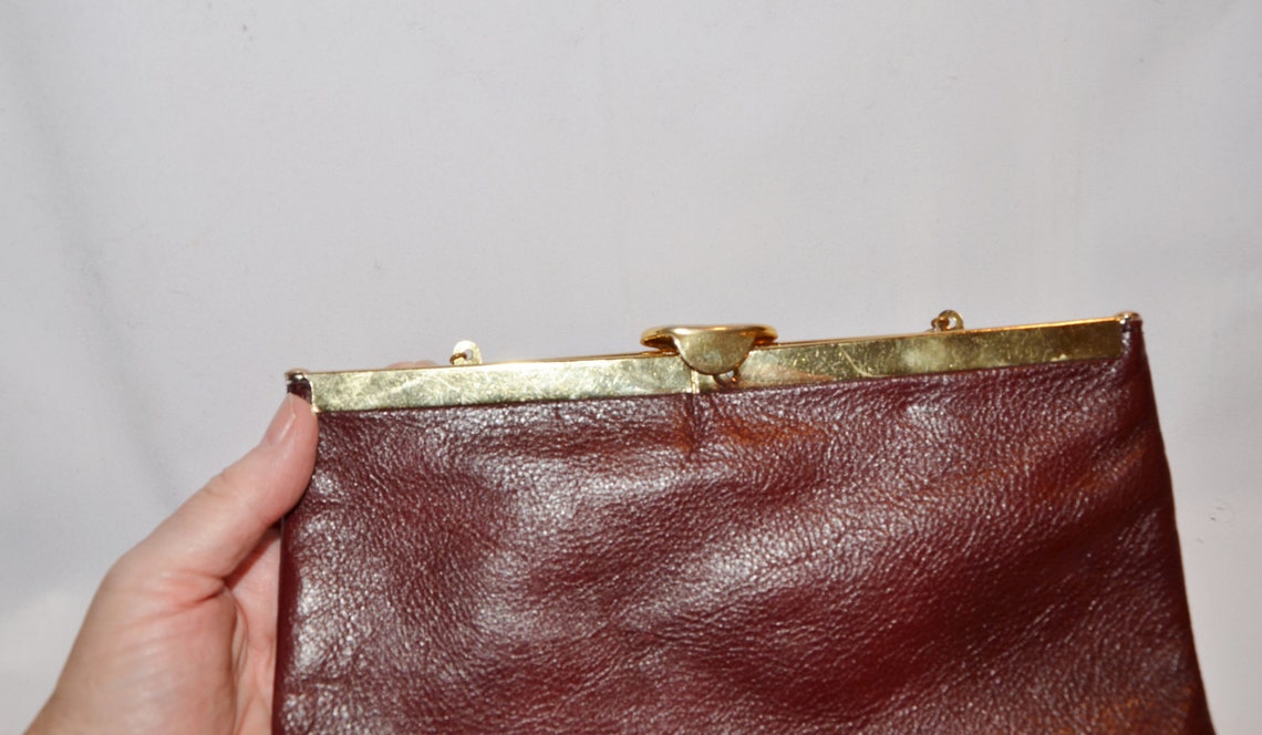 burgundy and gold clutch bag
