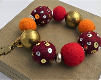 Bead bracelet, felted wool beads, sequins, aged golden bronze brass beads, bronze metal charms