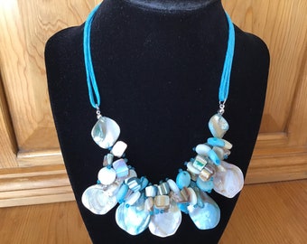 Aqua and Beige Mother of Pearl Shells and Discs Gather to Shine in This Adjustable Collar Necklace with Aqua Cord Ends