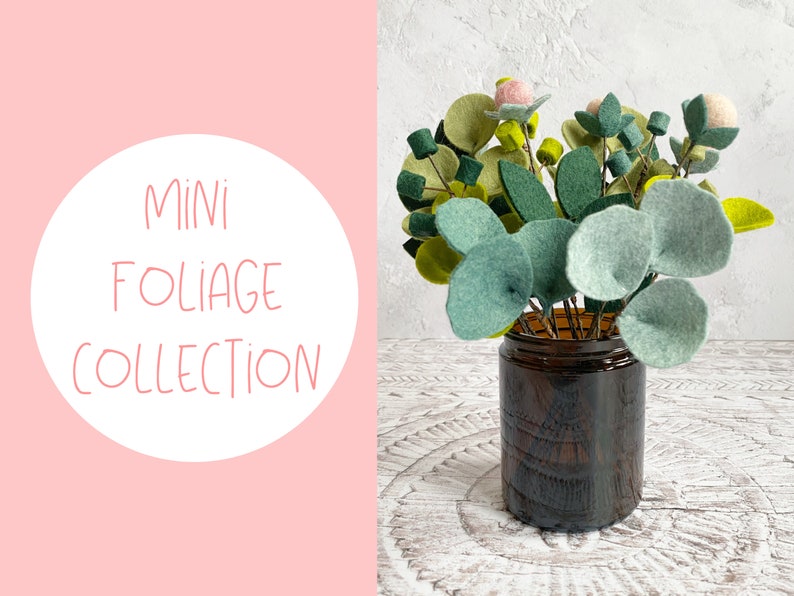 K&ouml;nnte beinhalten: Eine Sammlung von Filzlaub in einer braunen Glasvase. Das Laub ist in Gr&uuml;nt&ouml;nen gehalten und enth&auml;lt kleine rosa Filzblumen. Der Text "MINI FOLIAGE COLLECTION" befindet sich auf einem rosa Hintergrund.