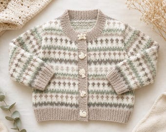 May include: A long-sleeve knit cardigan featuring a fair isle pattern in shades of beige, sage green, and white. The garment has a ribbed crew neckline, cuffs, and hem, and is fastened with five distinct white buttons shaped like nature motifs.