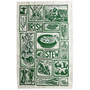 May include: Green and white kitchen tea towel with a design of Irish stew ingredients, including onions, carrots, potatoes, and herbs. The text "Irish Stew" is printed on the towel.